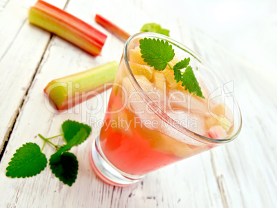 Lemonade with rhubarb and mint in glassful on board