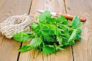 Nettle with a knife and twine on board