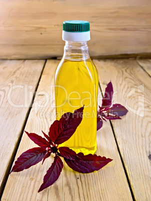 Oil with amaranth in bottle on light board