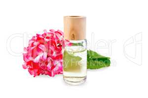 Oil with pink geraniums in glass bottle