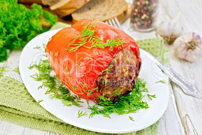 Pepper stuffed meat with dill in plate on board