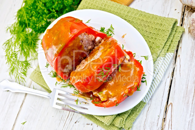 Pepper stuffed meat with sauce in plate on table