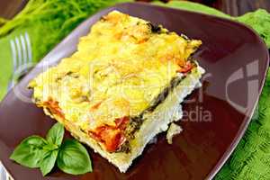 Pie potato with tomato and spinach on board