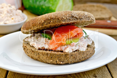 Sandwich with cream and salmon on the board