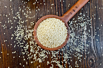 Sesame seeds in ladle on board top