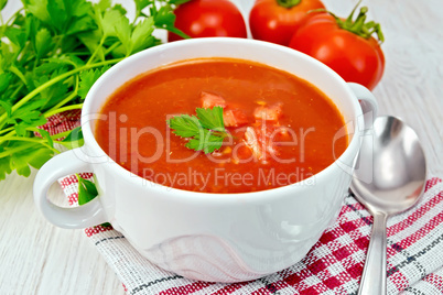 Soup tomato on napkin with pieces on board