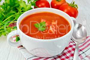 Soup tomato on napkin with pieces on board