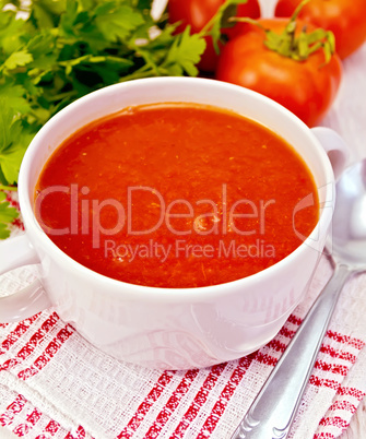 Soup tomato on napkin with spoon