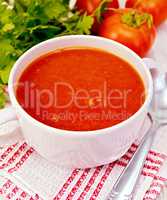 Soup tomato on napkin with spoon