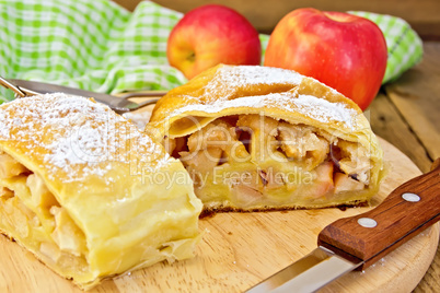 Strudel with apples and napkin on board