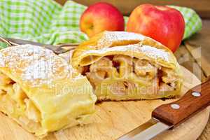 Strudel with apples and napkin on board