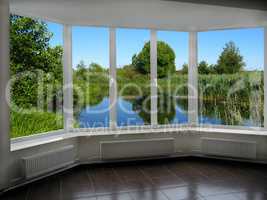 modern window with view of summer lake