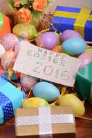 Arrangement of Gift Boxes in Wrapping Paper with Checkered Ribbons and Decorated Easter Eggs