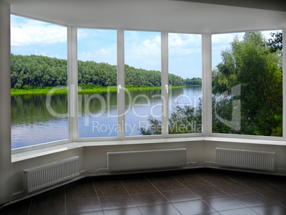 big windows with window overlooking the summer river