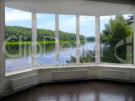 big windows with window overlooking the summer river