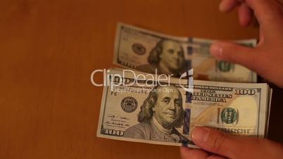 Female hand holding dollars isolated on white background