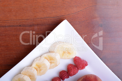 peach raspberries bananas close up as health food concept