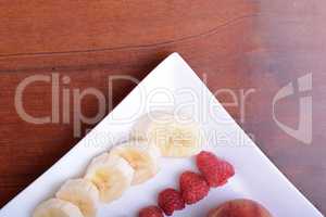 peach raspberries bananas close up as health food concept