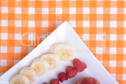 peach raspberries bananas close up as health food concept