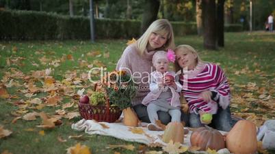 Mom and Two Daughters in Autumn Park