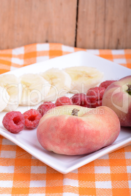 peach raspberries bananas close up as health food concept