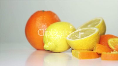 orange and lemon rotation on the table, close-up