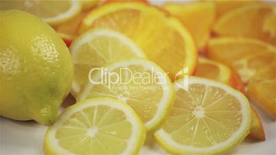 orange and lemon rotation on the table, close-up