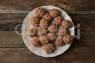 Raw meatballs on the wooden table
