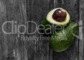 green avocados on wood table