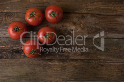 Fresh, ripe tomatoes on an old wooden board..