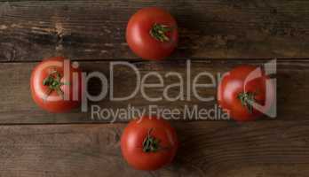 Fresh, ripe tomatoes on an old wooden board.tomatoes on wood .