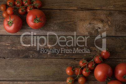 Fresh, ripe tomatoes on an old wooden board.tomatoes background