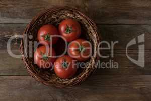 Fresh, ripe tomatoes on an old wooden board.tomatoes on wooden b