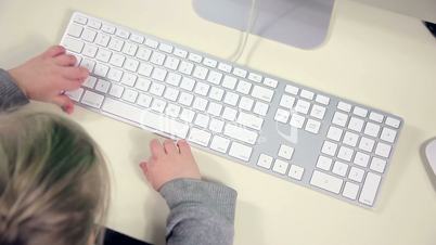 Little girl using a keyboard