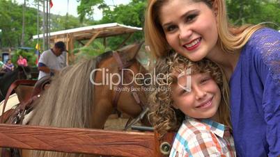 Woman And Boy Posing With Pony