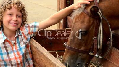 Smiling Boy With Feeding Horse