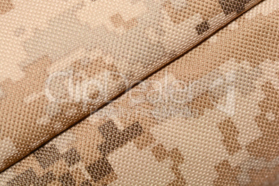 close up of worn out olive green tone camouflage fabric