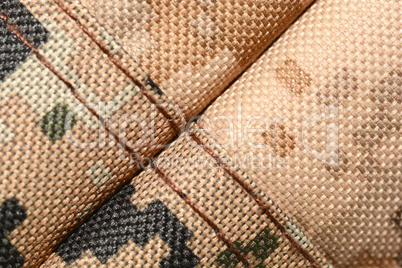 close up of worn out olive green tone camouflage fabric