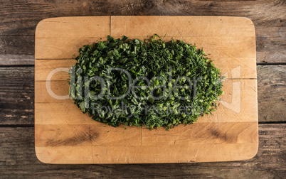 parsley and dill on chopping board