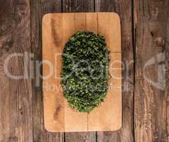 dill and parsley on wooden board