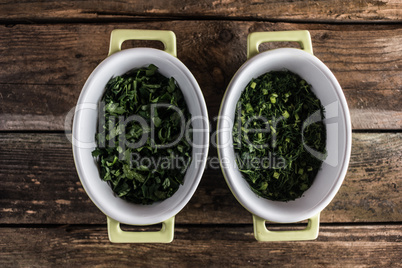 parsley in dish on wood