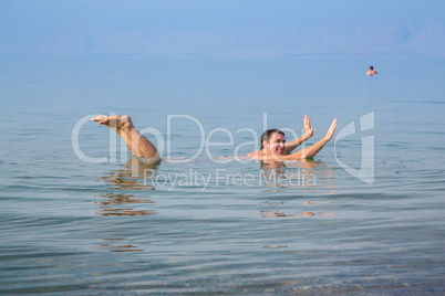 Man fooling around in the Dead Sea, Jordan
