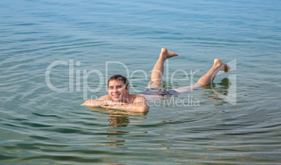 Man floating in the Dead Sea, Jordan