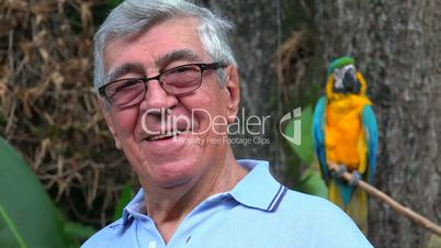 Senior Man Smiling With Parrot