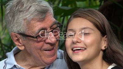 Curious Grandfather And Teen Girl Pointing