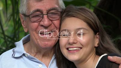 Grandfather And Teen Girl Smiling