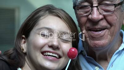 Grandfather And Teen Girl With Lollipops