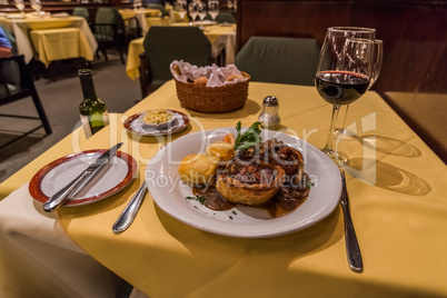 Steak dinner with wine on restaurant table
