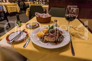 Steak dinner with wine on restaurant table