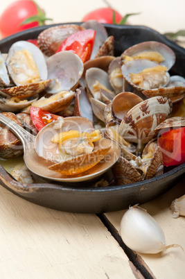 fresh clams on an iron skillet